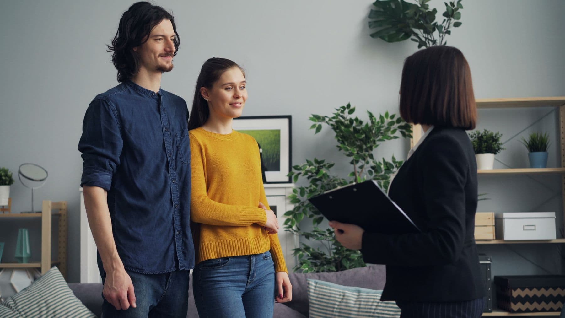 A property agent consulting with clients in a home interior